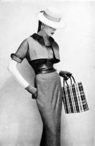 Slim sheath dress topped with a bolero jacket as seen in Harper’s Bazaar, April 1954