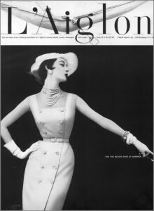 Dovima, silk and Orlon sheath by L’Aiglon, hat by John Frederics, photo by Wingate Paine, Vogue, May 1, 1953